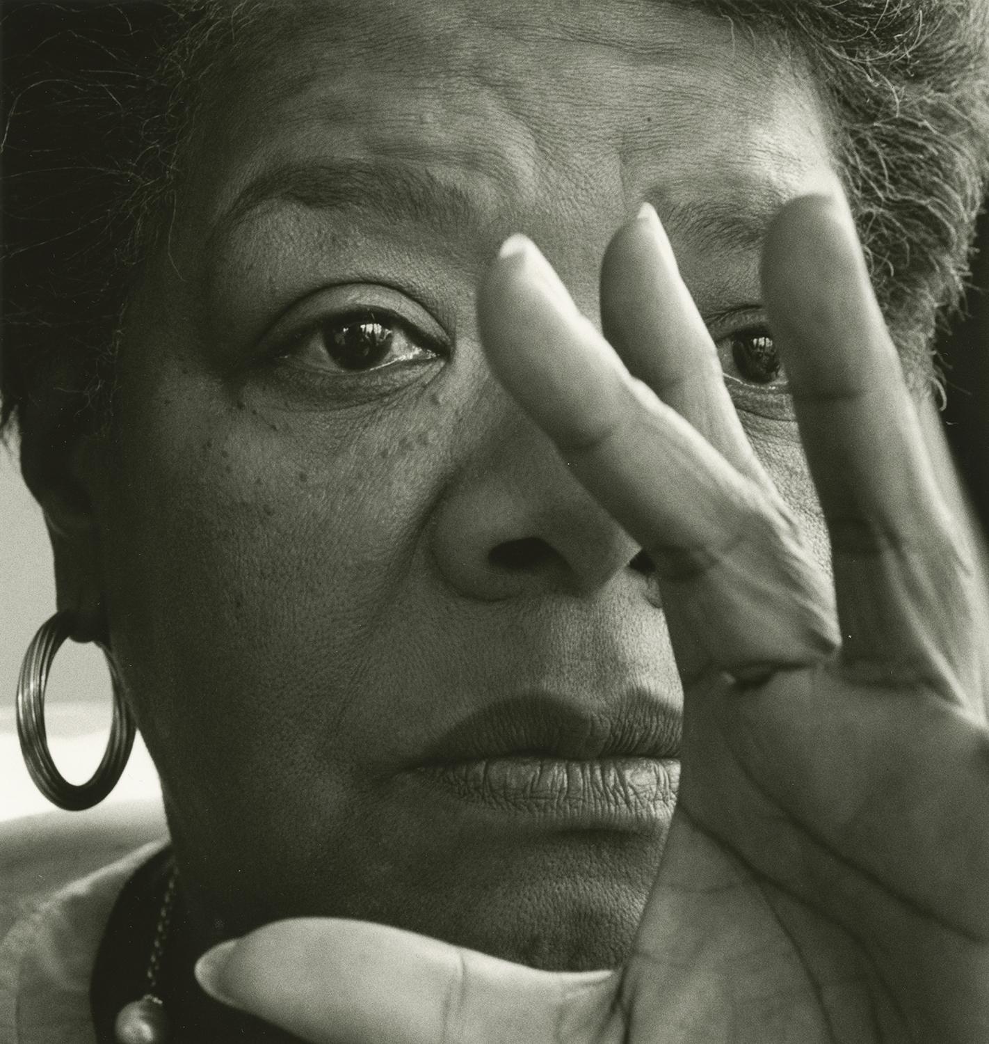 Photograph of Maya Angelou with her hand in front of her face