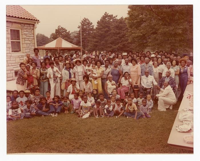 A color photograph of a large gathering of people outdoors.