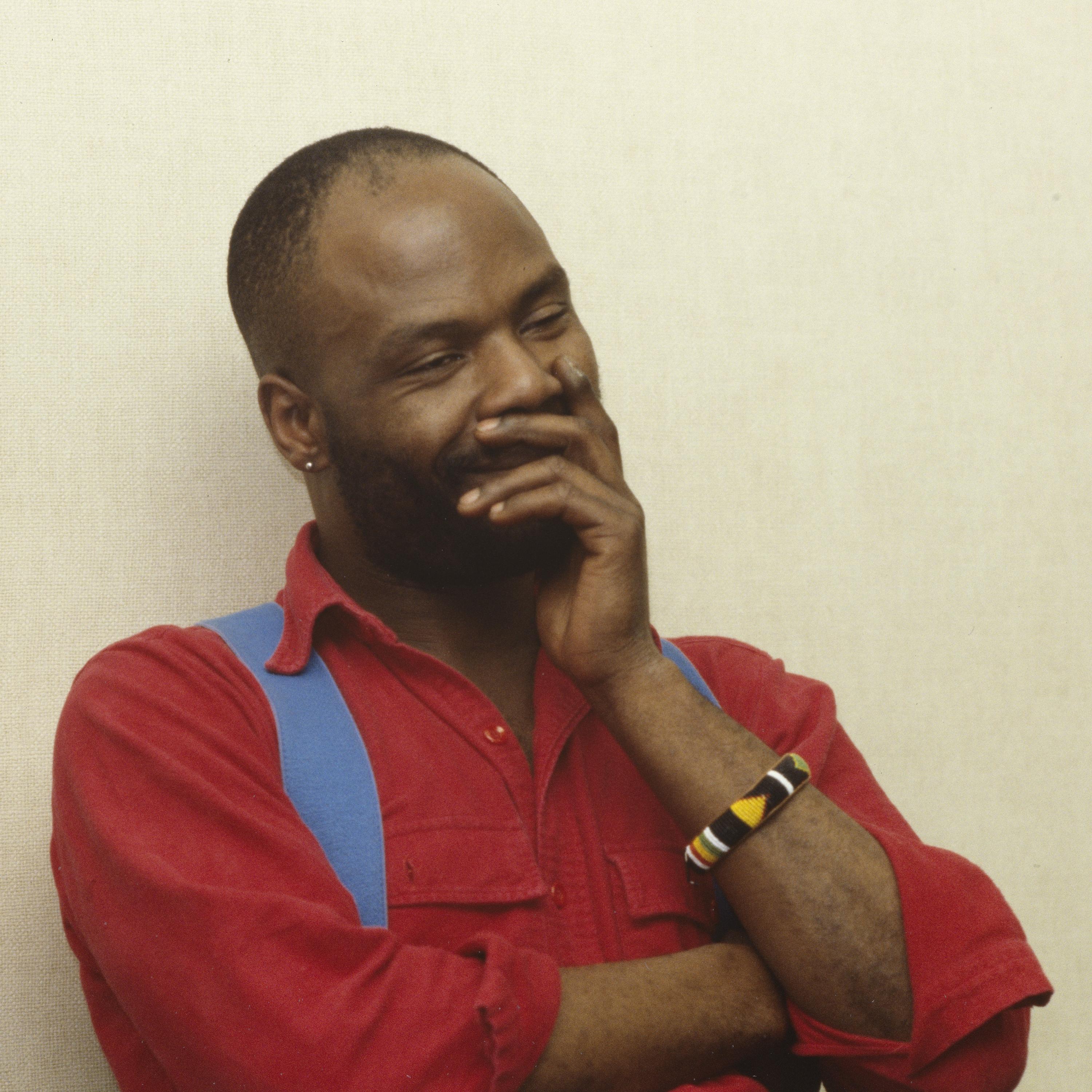 A man in red shirt staring off to the side.