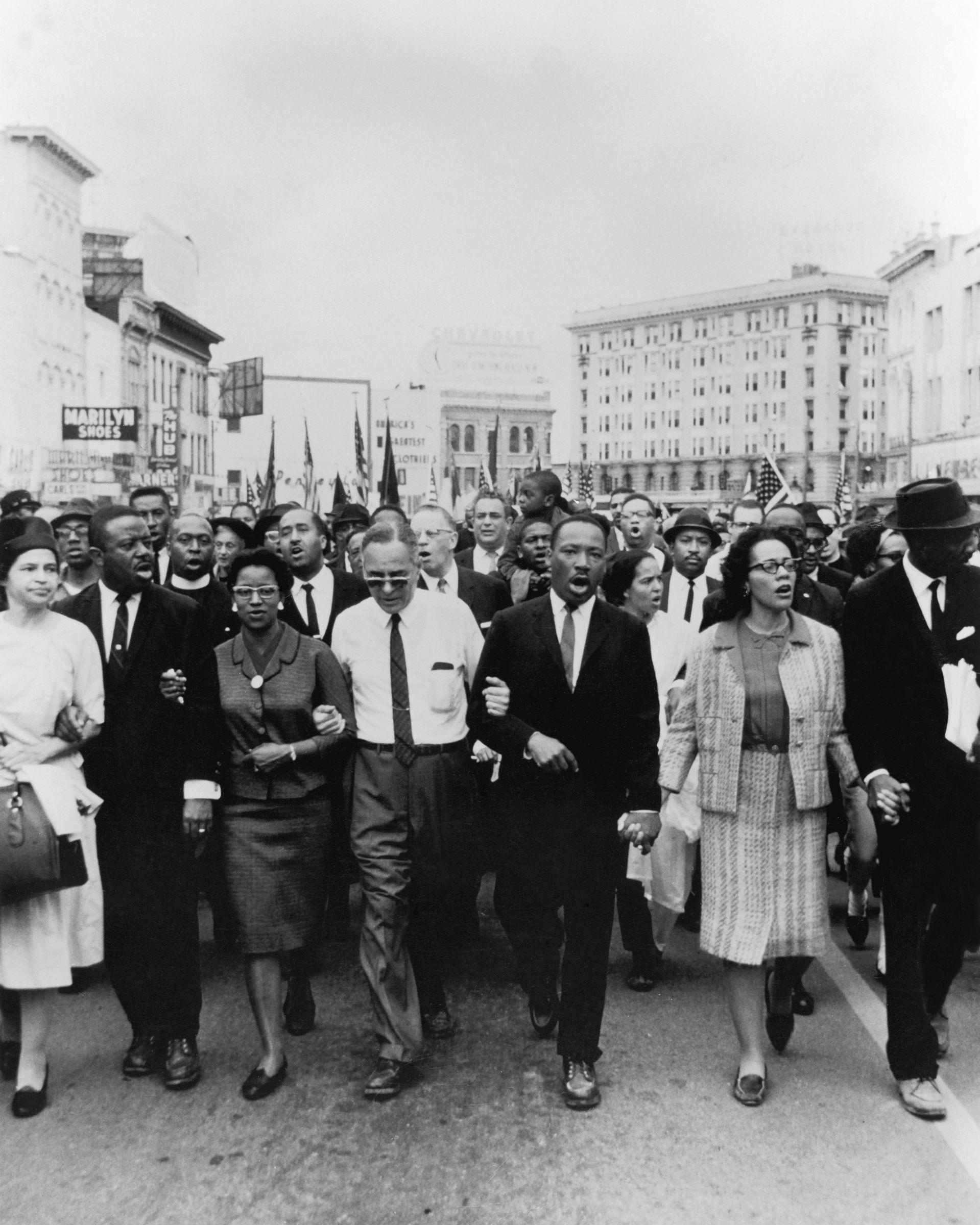 Dr. Martin Luther King, Jr. and Coretta Scott King lead a group of protesters during the Selma to Montgomery March, including fellow activists Rosa Parks, Ralph and Juanita Abernathy, Dr. Ralph Bunche, and Fred Shuttlesworth Montgomery, Alabama, 1965
