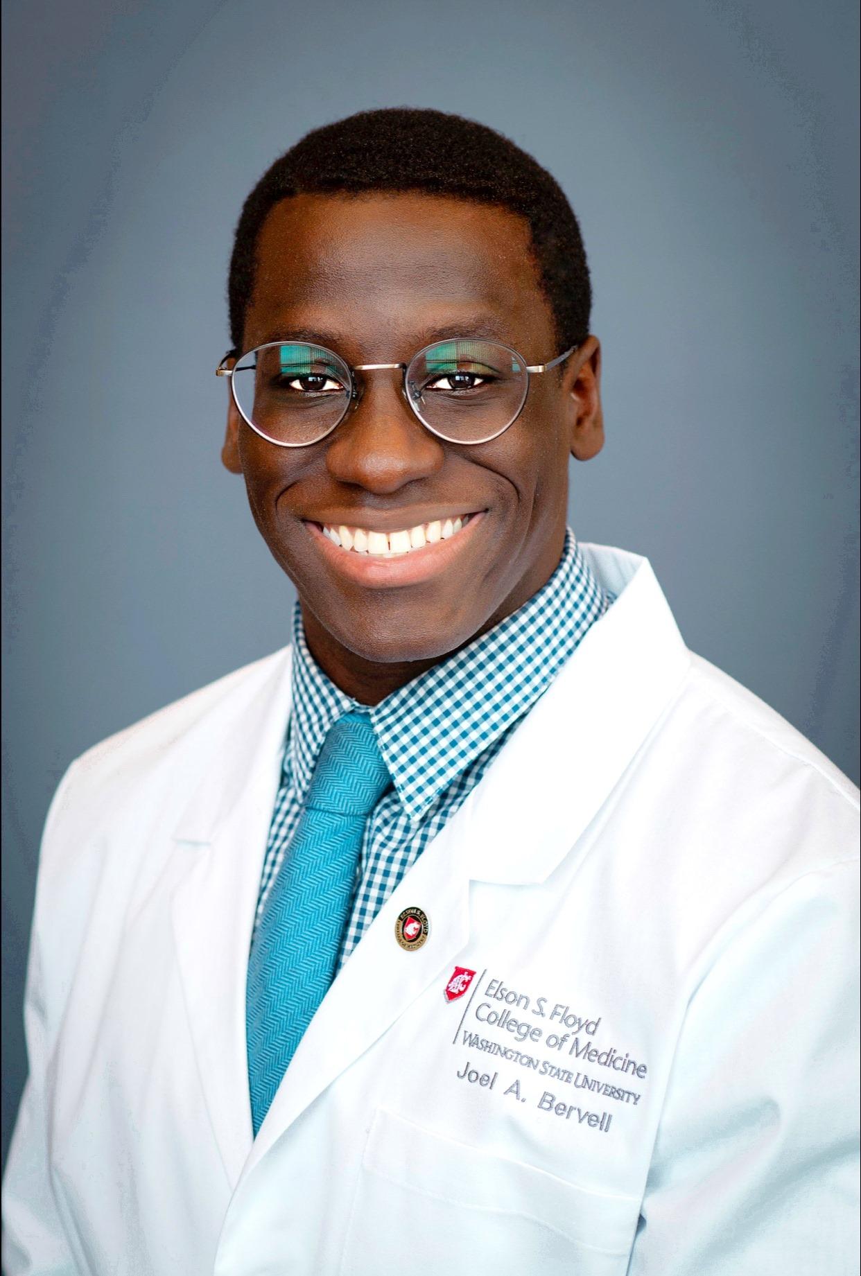 A male African American medical student smiles at the camera