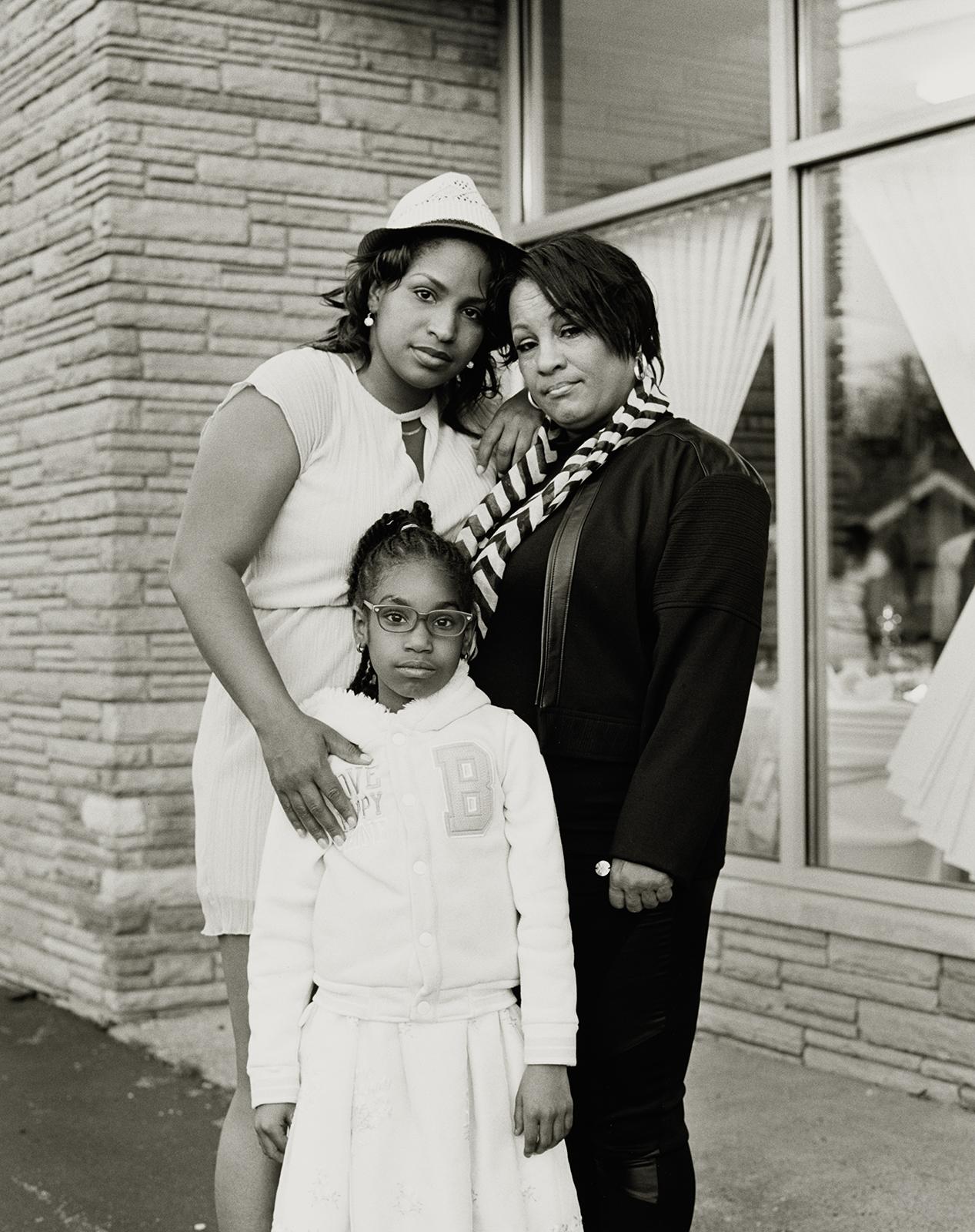 Shea Cobb, her mother Ms. Renée and her daughter Zion standing outside a banquet hall.