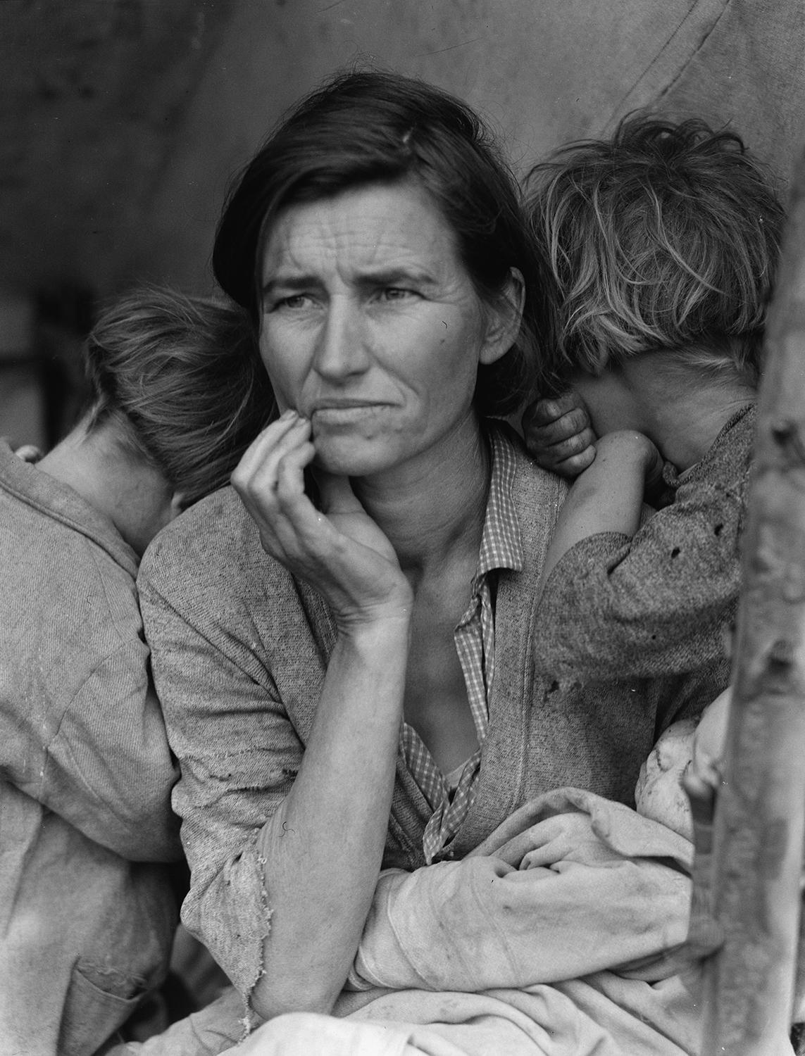 A portrait of a woman and two children.