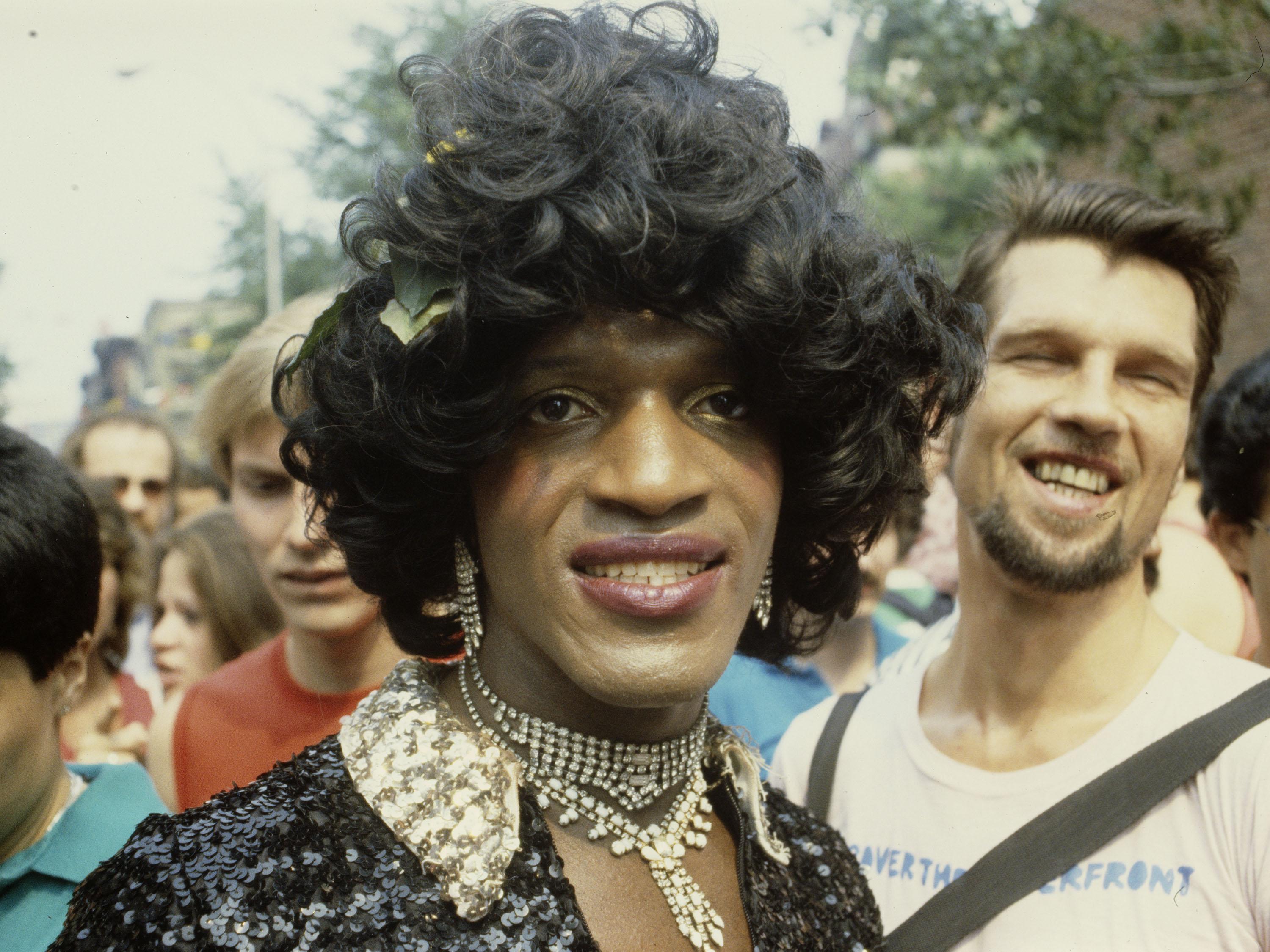 A color photographic slide depicting activist Marsha P. Johnson within the crowd at a New York Gay Pride March.