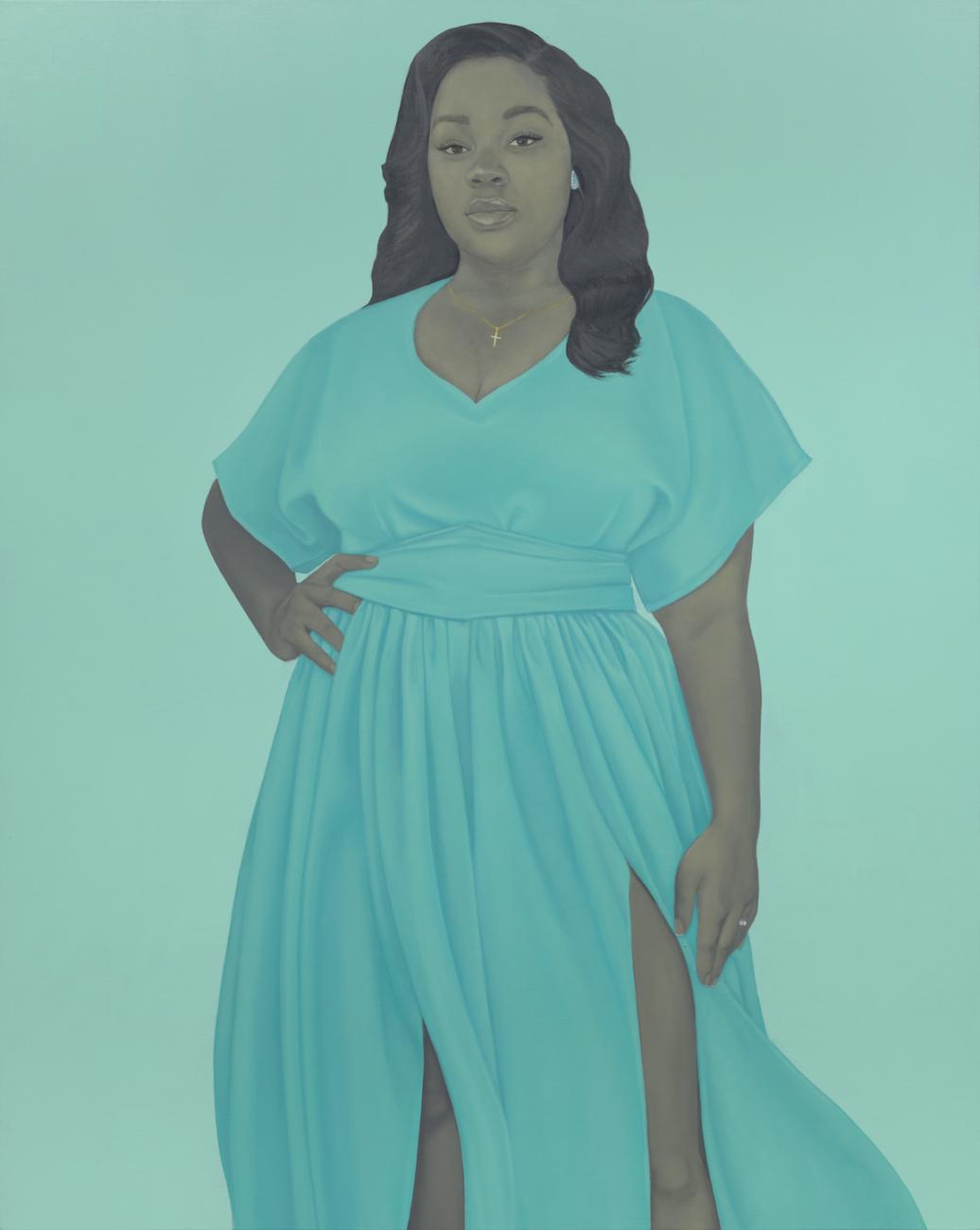 Picture of Breonna Taylor. Taylor has right hand on waist, and is standing in a flowing teal blue dress.