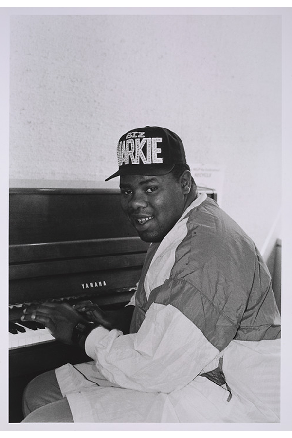 Biz Markie sitting at a piano at the offices of Cold Chillin' Records.