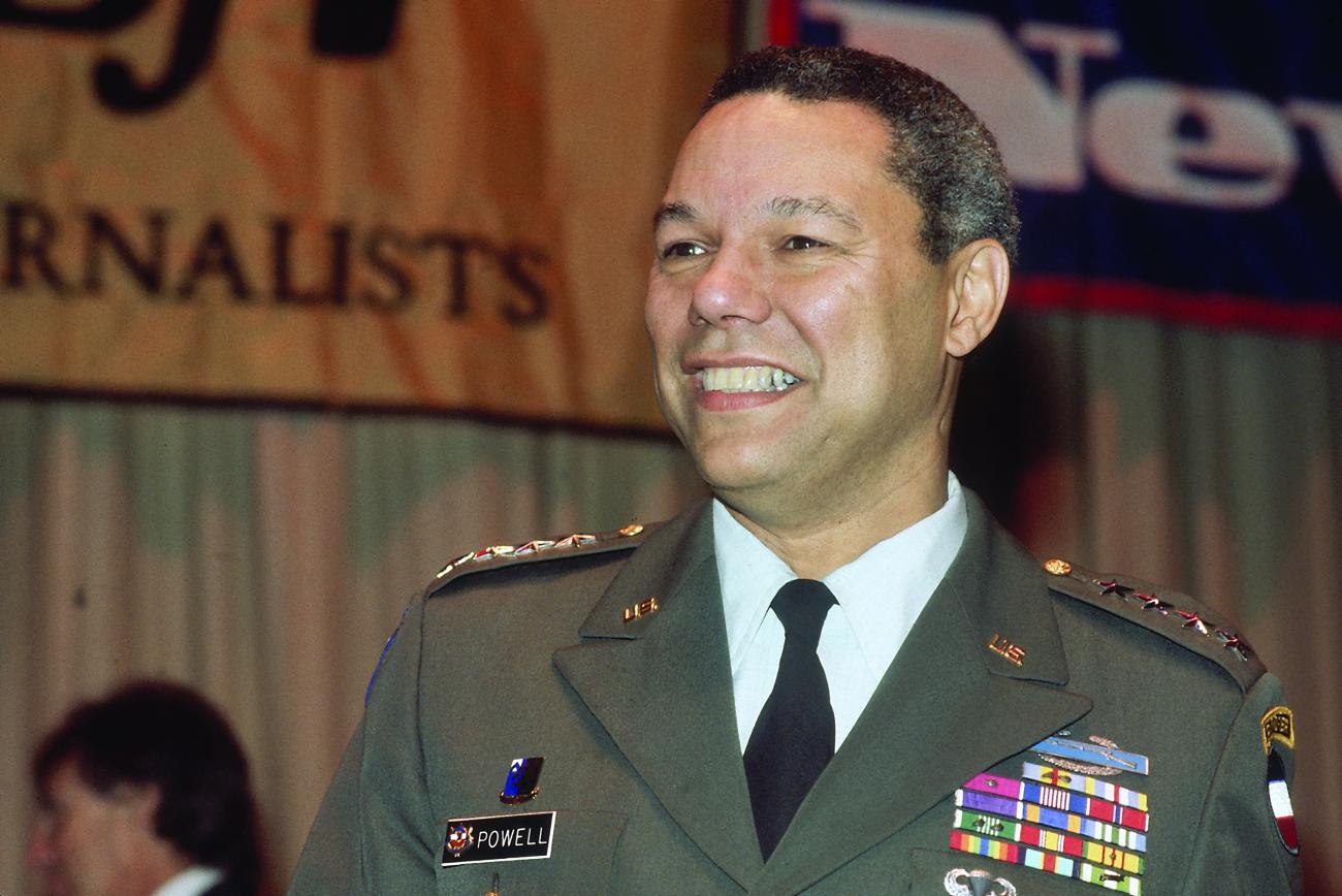 Colin Powell speaks at the 1992 Buffalo Soldiers Monument Dedication in Fort Leavenworth, Kansas. Powell is smiling, facing the camera. He is wearing military greens shown from the chest up.