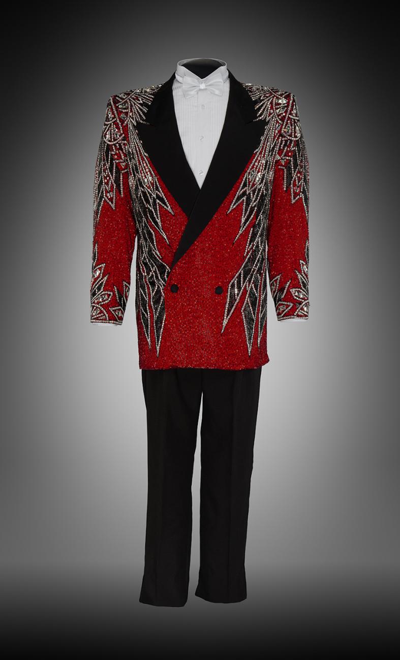 A sequined suit jacket with shirt, tie, and pants.