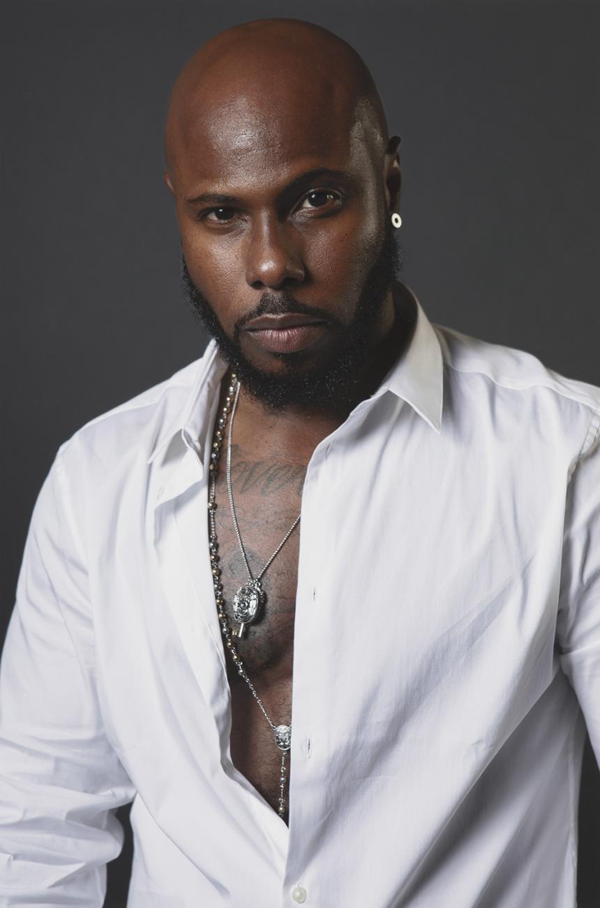 Photograph of a man in a white shirt.