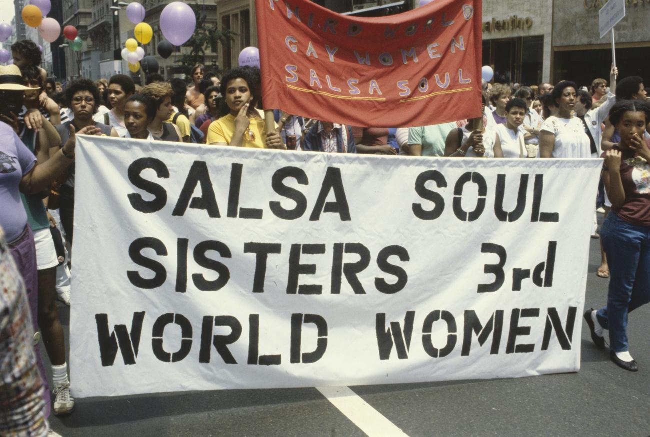 Photograph of women marching with a sign that reads "Salsa soul sisters 3rd world women"
