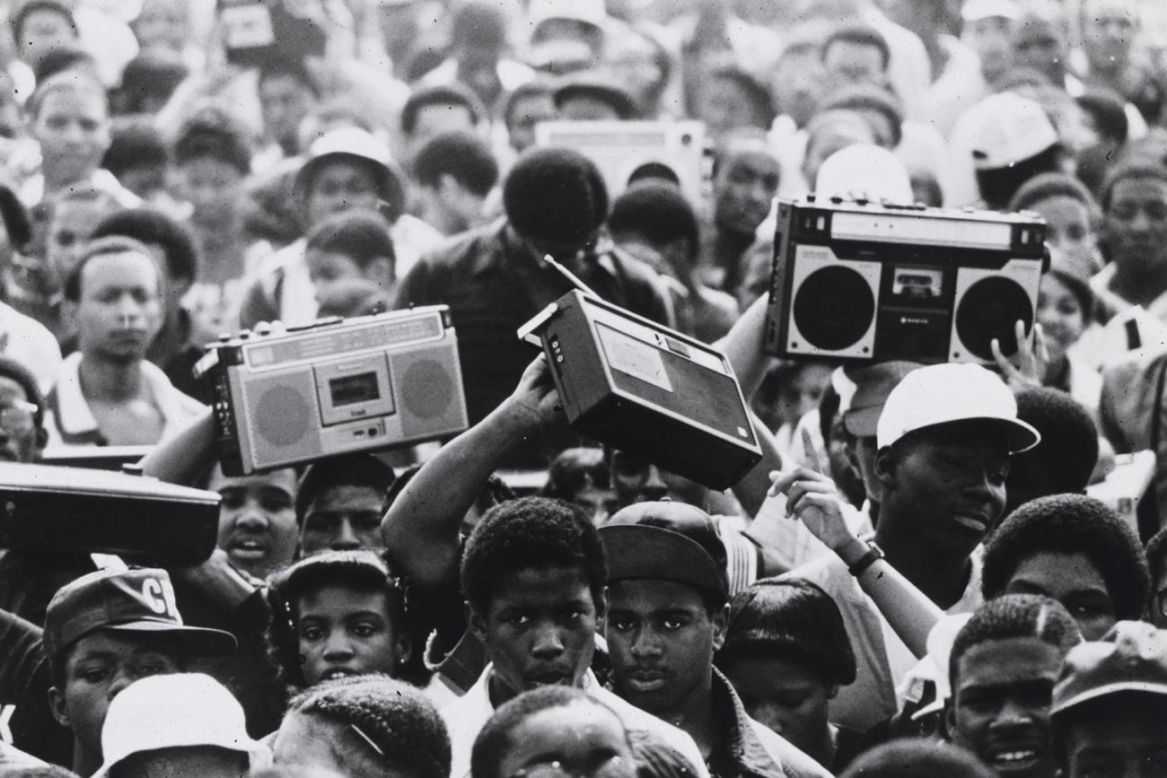 A black and white photo of a crowd of people at the Anacostia Park Community Day. The majority of people in this photo appear to be teens or young adults.