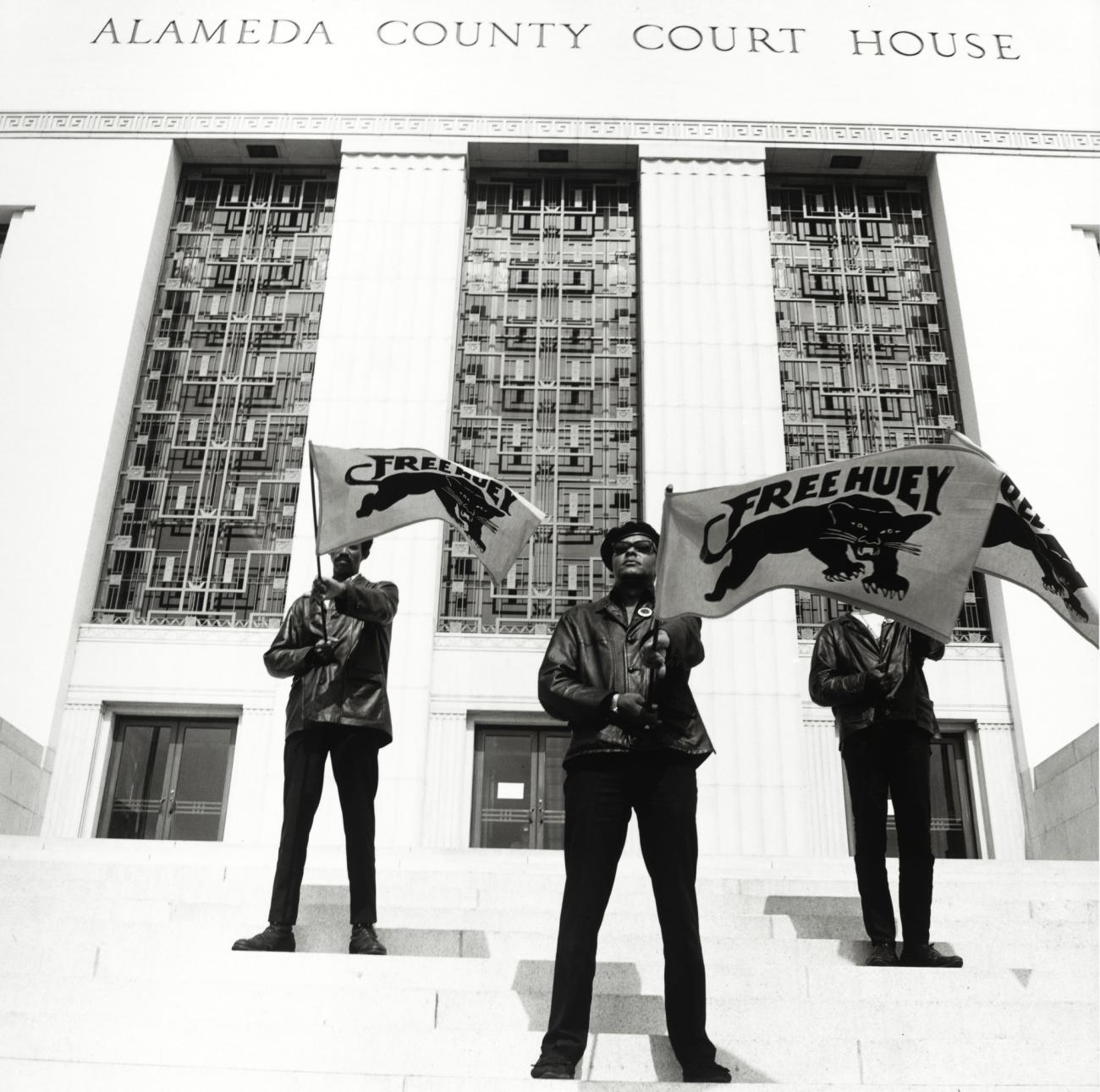 Three Black Panther Party members on the steps of Alameda County Court House
