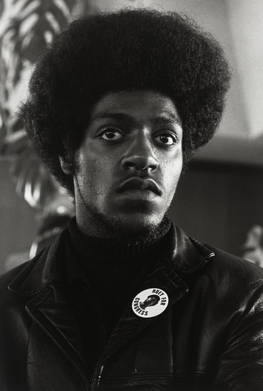 Photograph of a Black Panther Party member wearing a leather jacket and button. 
