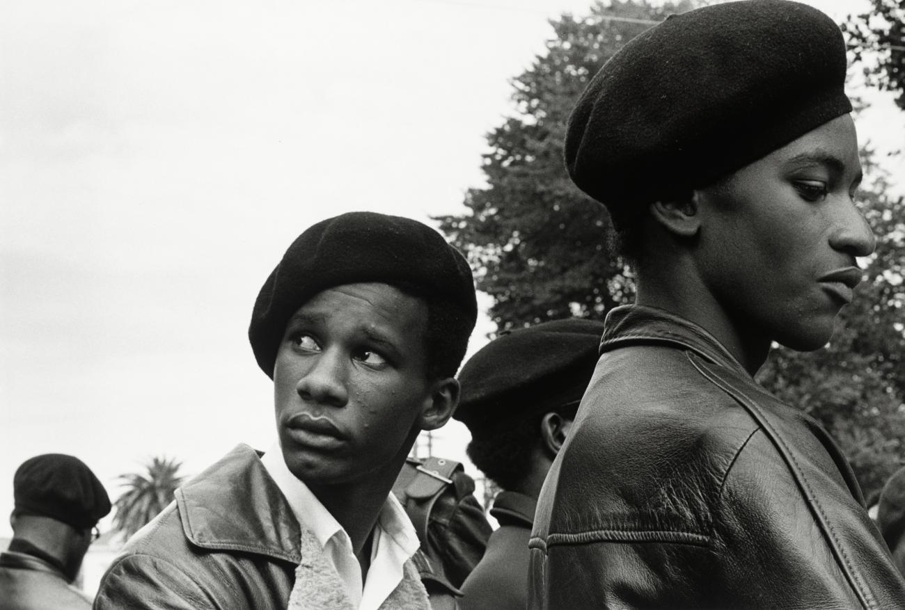 Photograph of two Black Panther Party members wearing berets. 