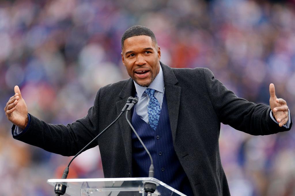 Michael Strahan speaks during the ceremony to retire his number at half time of the game