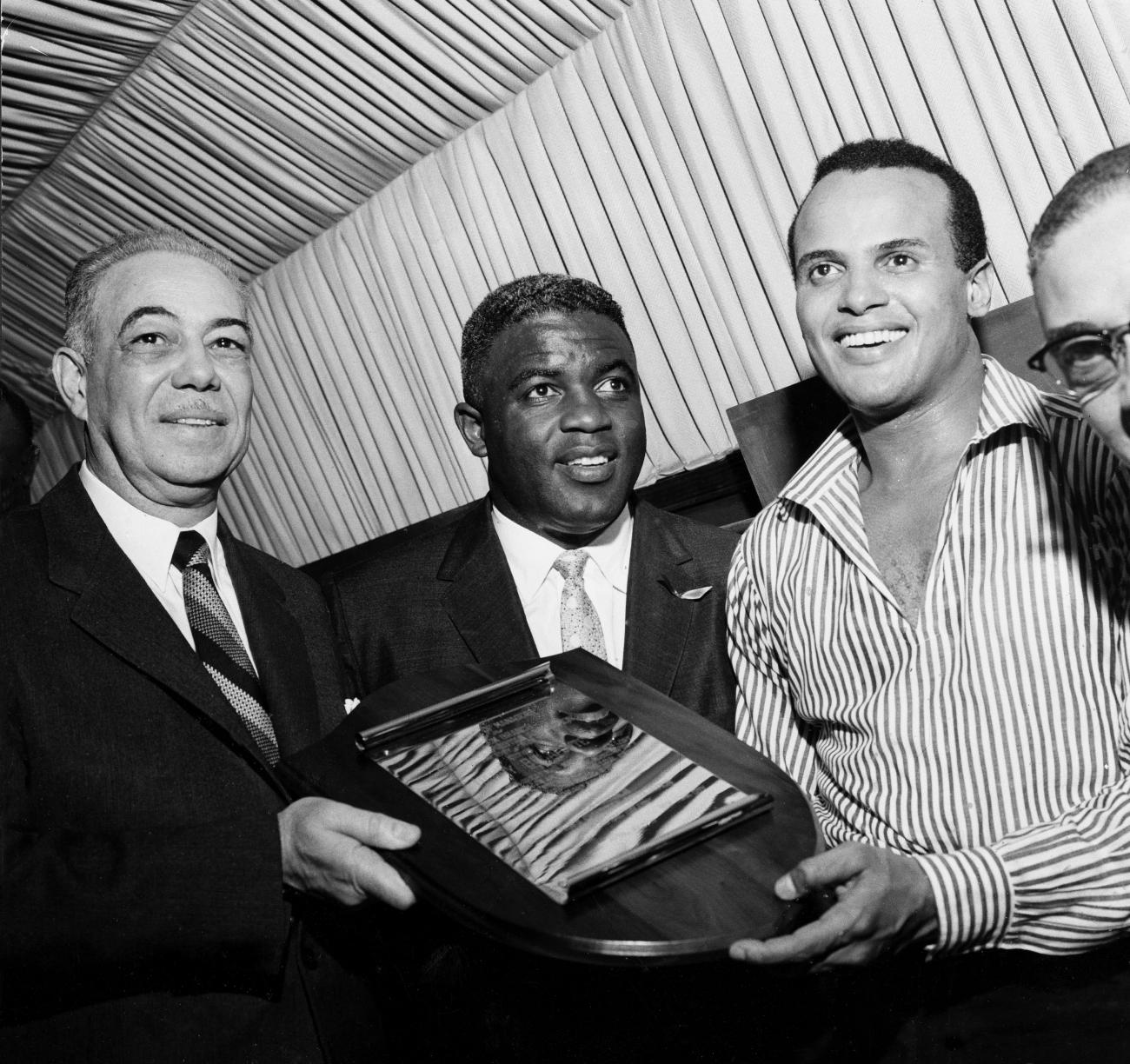 Actor and singer Harry Belafonte and baseball great Jackie Robinson receive an award.