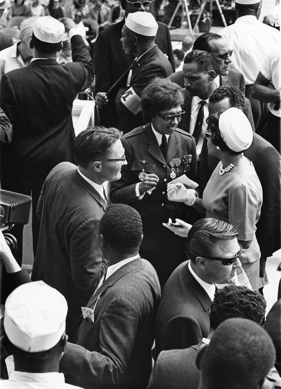 Josephine Baker is photographed talking to other march attendees