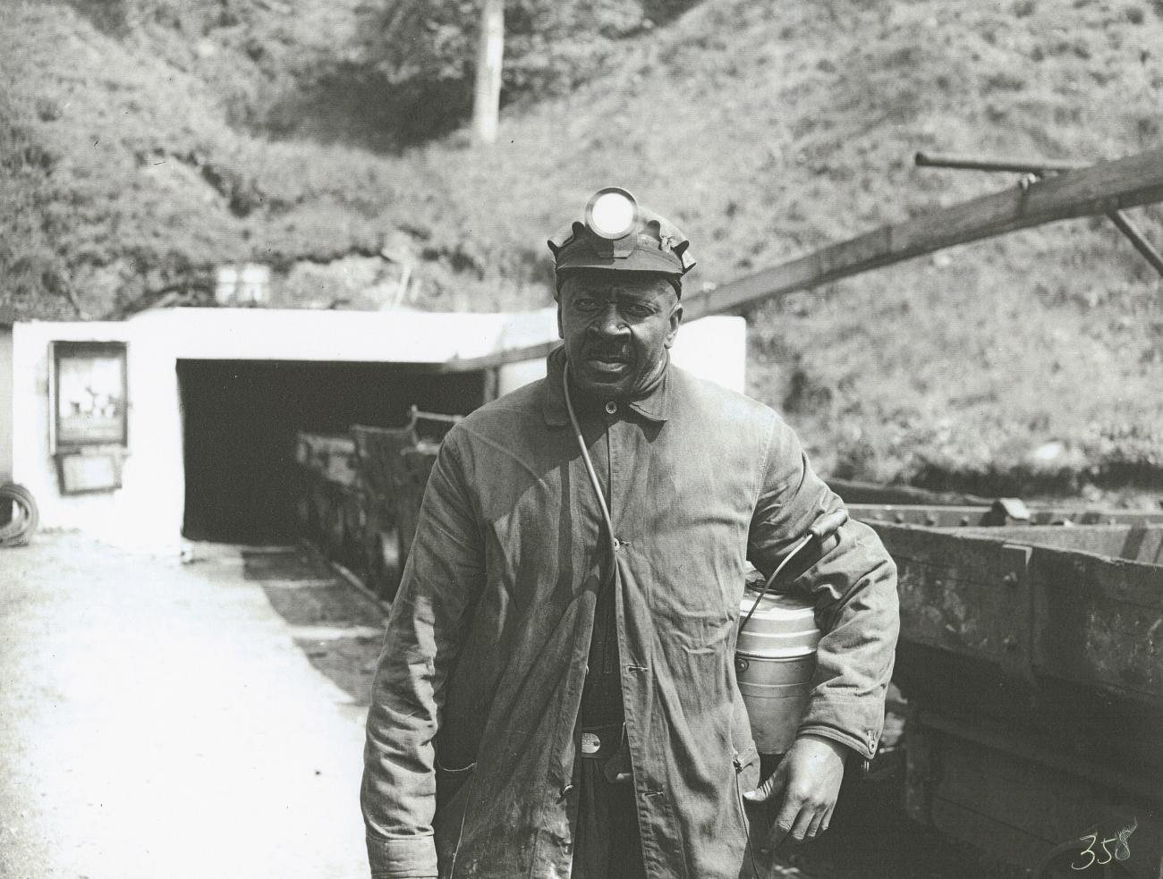 A coal miner outside a coal mine. 