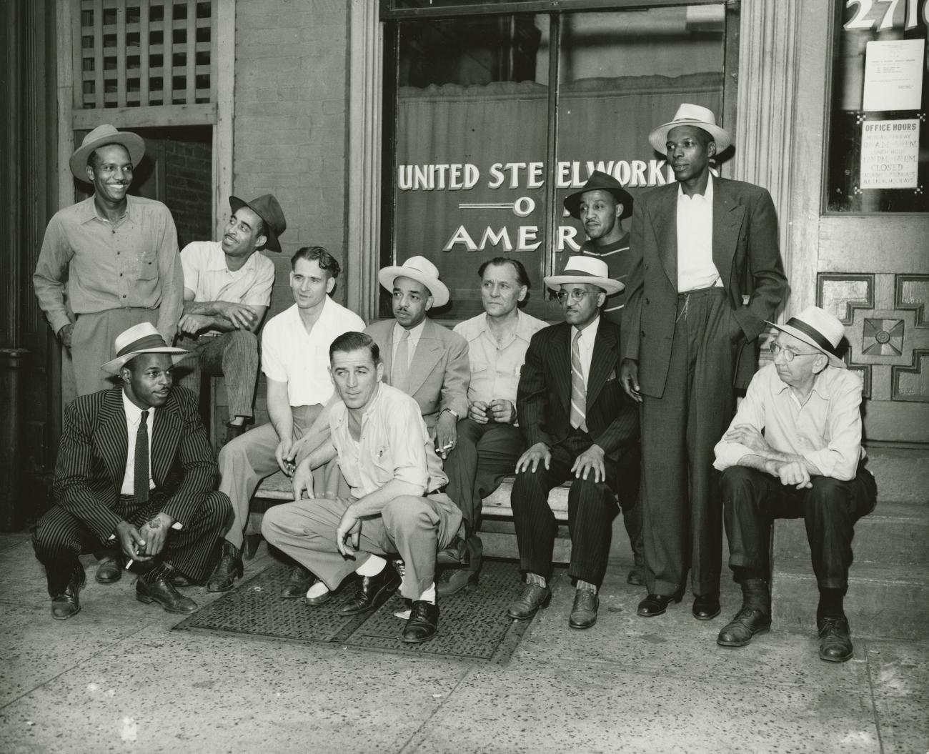 A group of men outside a building.