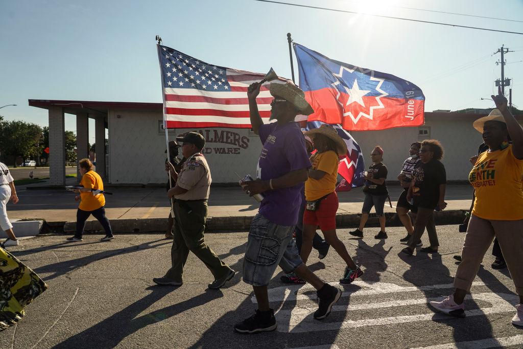 Members of Reedy Chapel African Methodist Episcopal Church march to celebrate Juneteenth on June 19, 2021 in Galveston, Texas. Juneteenth marks the emancipation of enslaved African American people in the United States and the Juneteenth National Independence Day became the 12th legal federal holiday signed on June 17th, 2021.