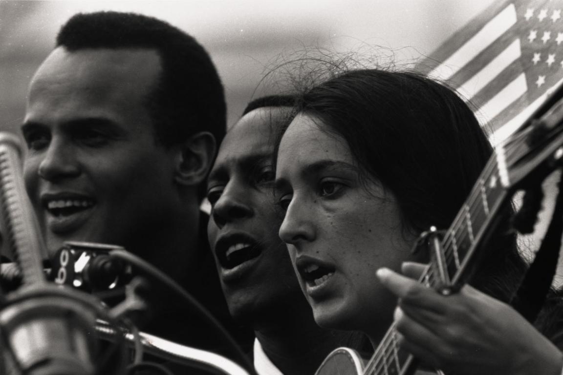 Photograph of Harry Belafonte, Leon Bibb, and Joan Baez singing at Selma to Montgomery March, 1965