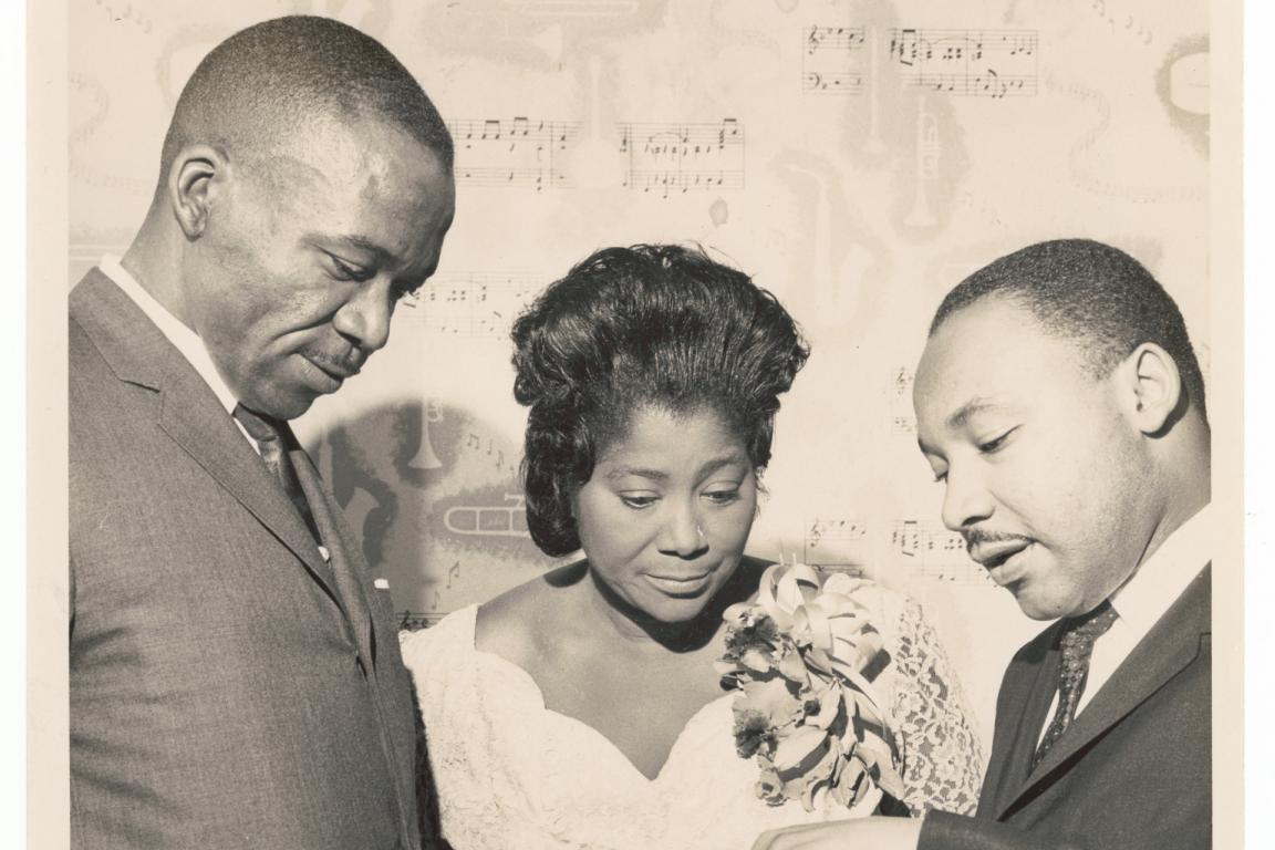 Mahalia Jackson standing with Dr. Martin Luther King Jr and another man.