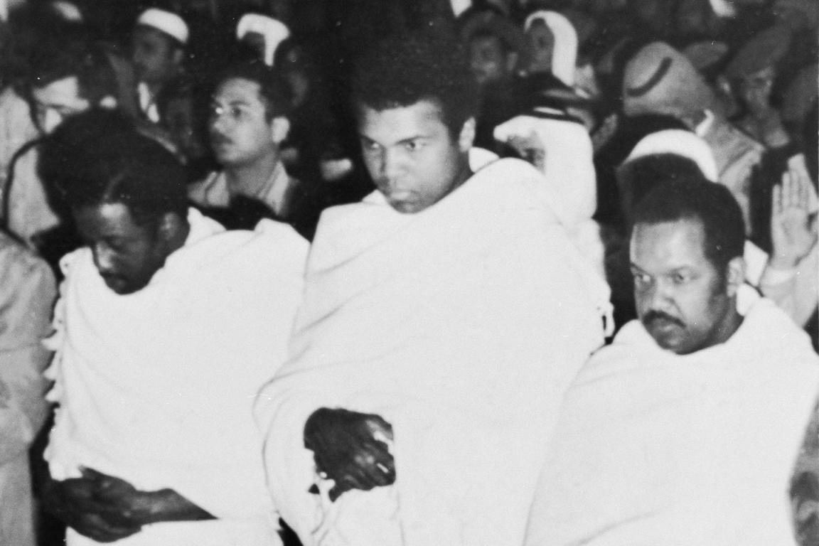 Flanked by fellow pilgrims, Muhammad Ali, former heavyweight champion of the world, prays inside the Holy Mosque in Mecca recently during his New Year's pilgrimage to the spiritual center of the Moslem world.