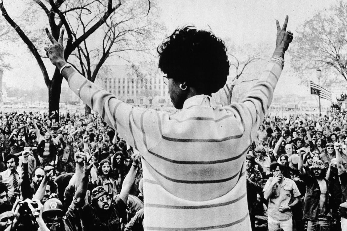 African American congresswoman Shirley Chisholm gives the peace sign to a crowd of protestors as she speaks to veterans on the Washington Mall, Washington, DC, April 1971.