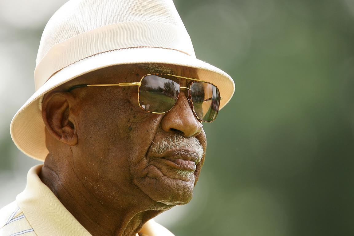 Charlie Sifford, the first African-American to play on the PGA Tour, watches Tiger Woods.