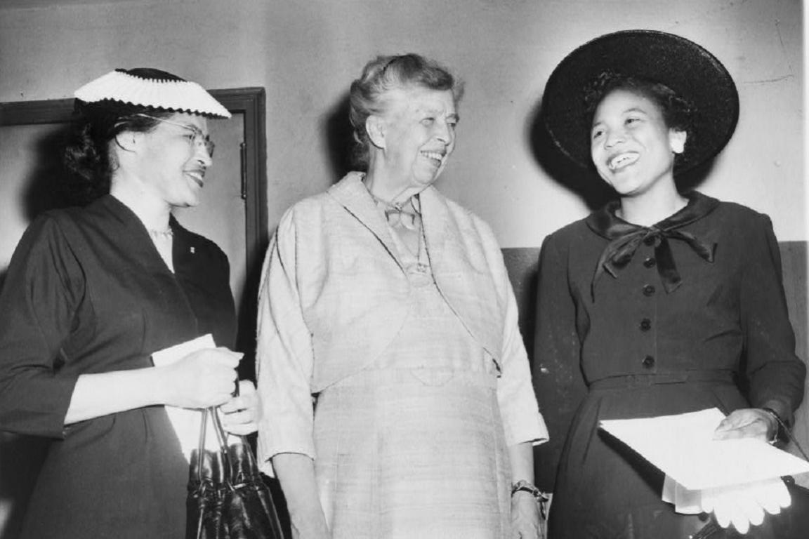Autherine Lucy, Eleanor Roosevelt, and Rosa Parks all stand smiling at each other.