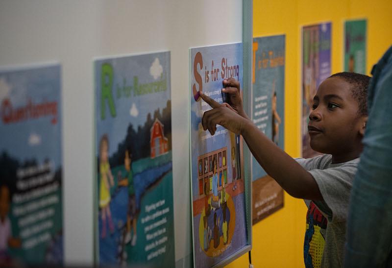 Early childhood education program participants engaging with materials from the Joyful ABCs book.
