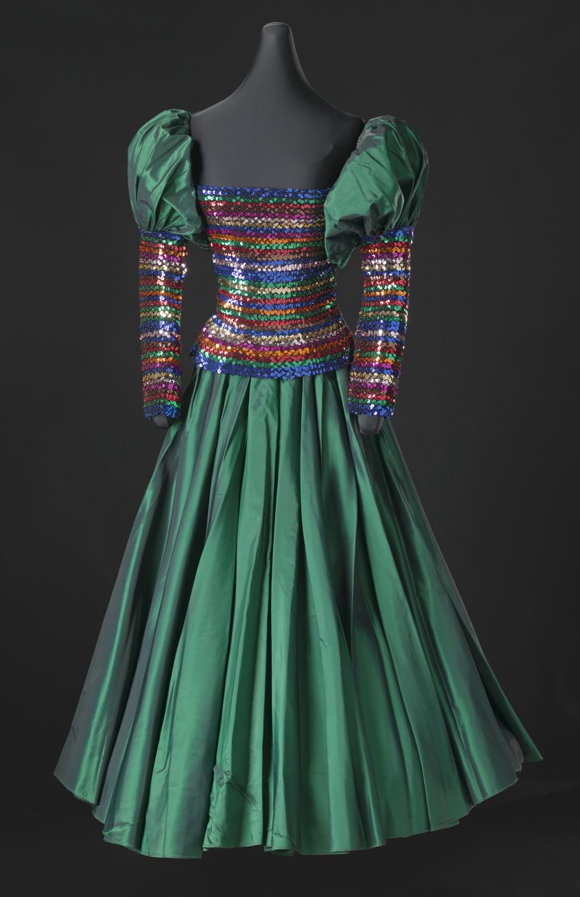 A fitted floor-length dress with rainbow colored sequins and beading designed by Peter Davy.