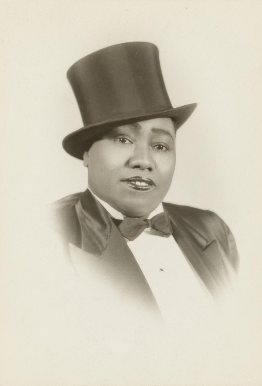Image of a woman wearing a tuxedo and top hat.