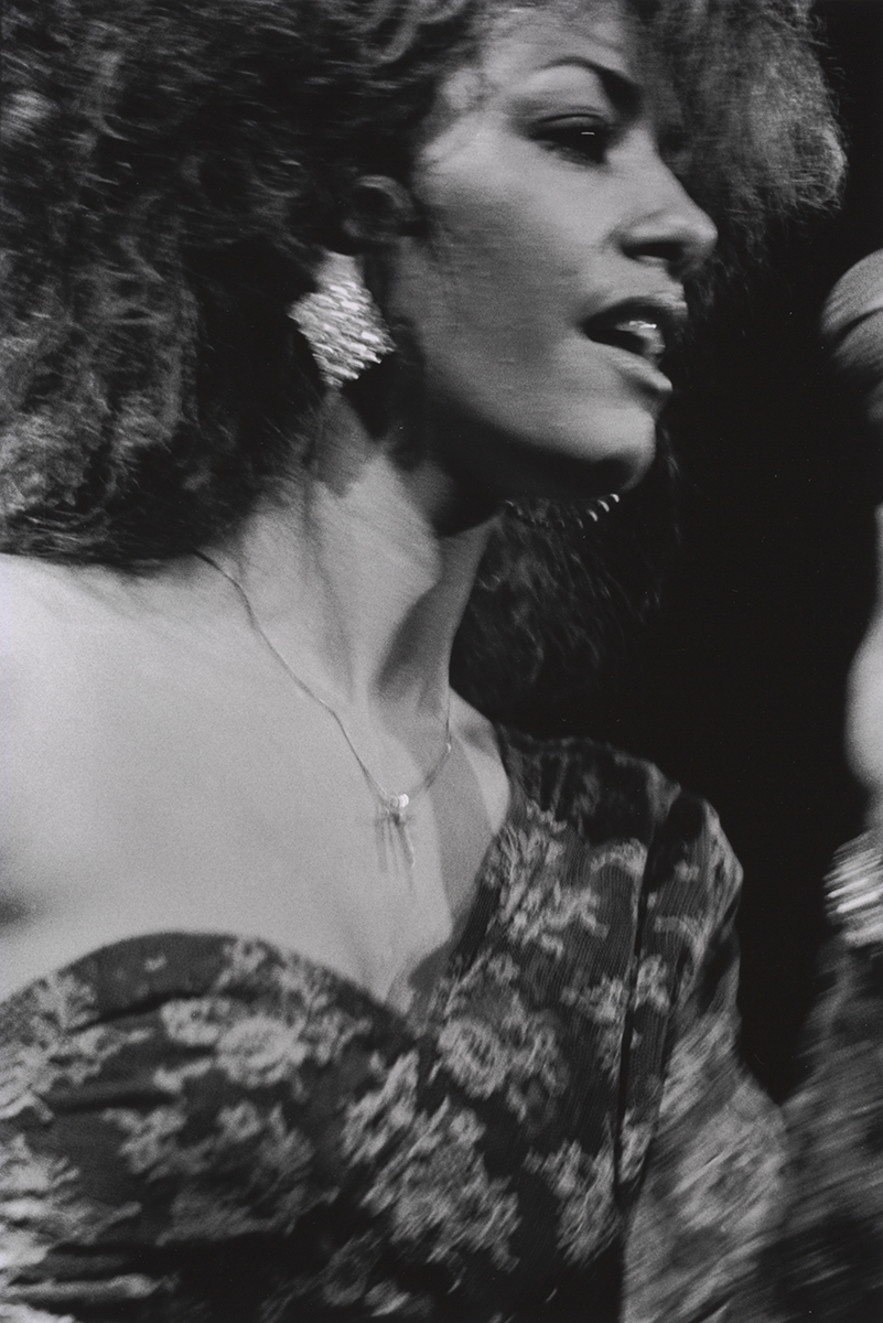 A black-and-white photograph of Sheila Escovedo, known as Sheila E., performing.