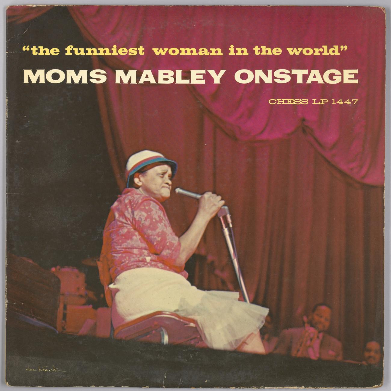 Album cover features a color photograph of Moms Mabley sitting on stage holding a microphone in her proper right hand.