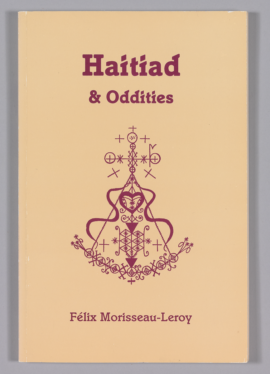 Tan paperback with red type on front cover. At center of front cover is a red religious symbol.