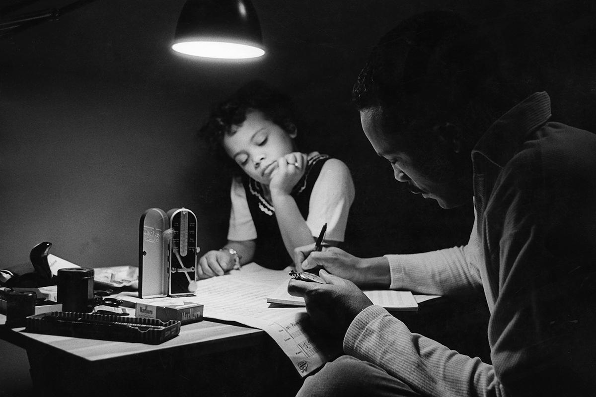 Jolie watches her father, Quincy Jones, measure time for a music score, c. 1961