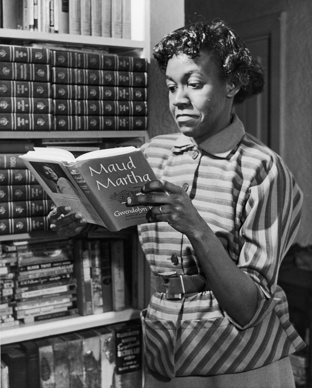 Poet Gwendolyn Brooks holds a copy of Maud Martha, the only book of adult fiction she authored, 1963