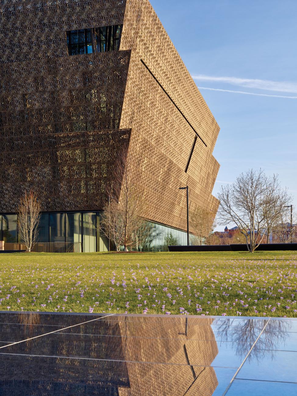 The National Museum of African American History and Culture is pictured reflected