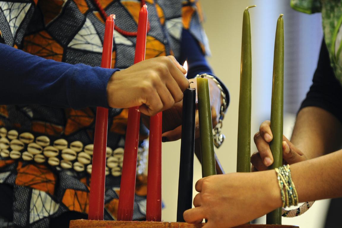 Candles are lit on the Kinara in a Kwanzaa celebration