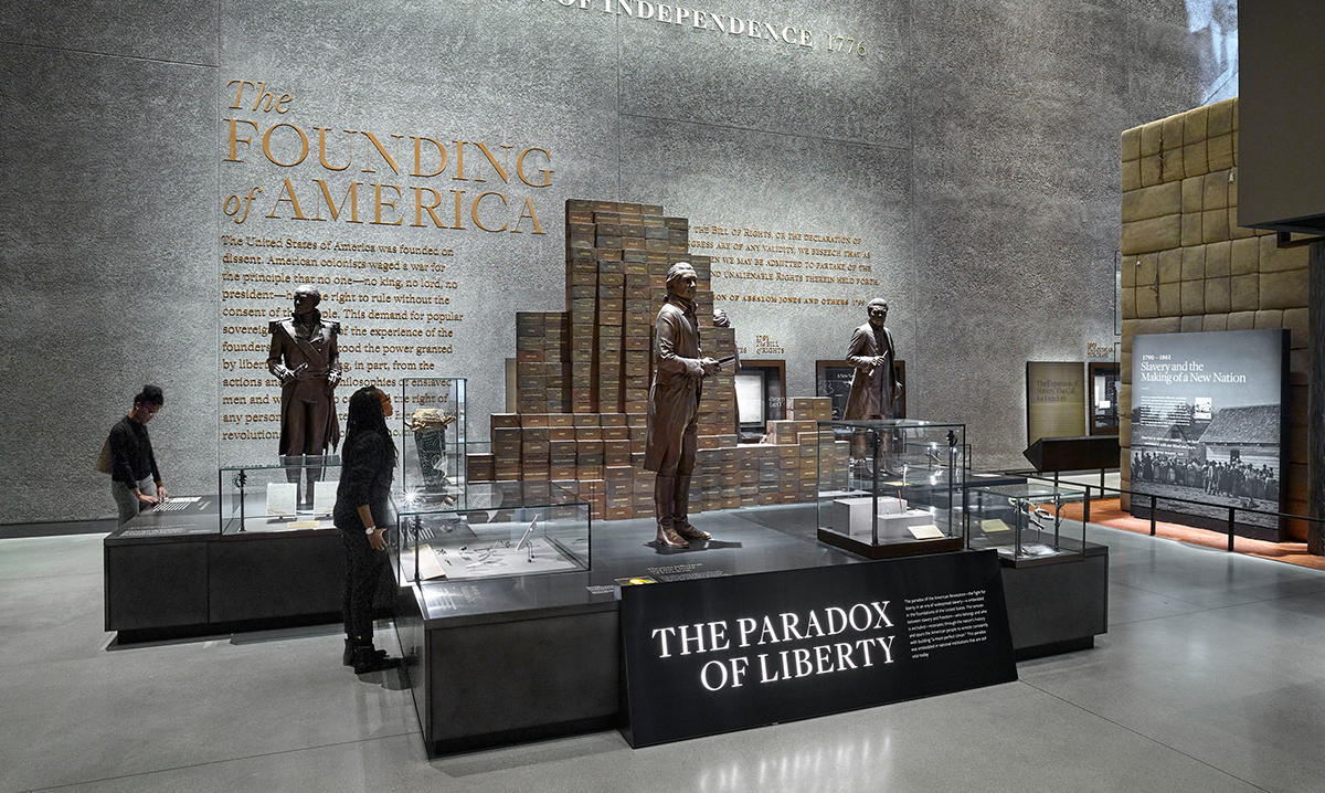 The Paradox of Liberty section of Slavery and Freedom featuring bronze statues of famous figures at the founding of America.