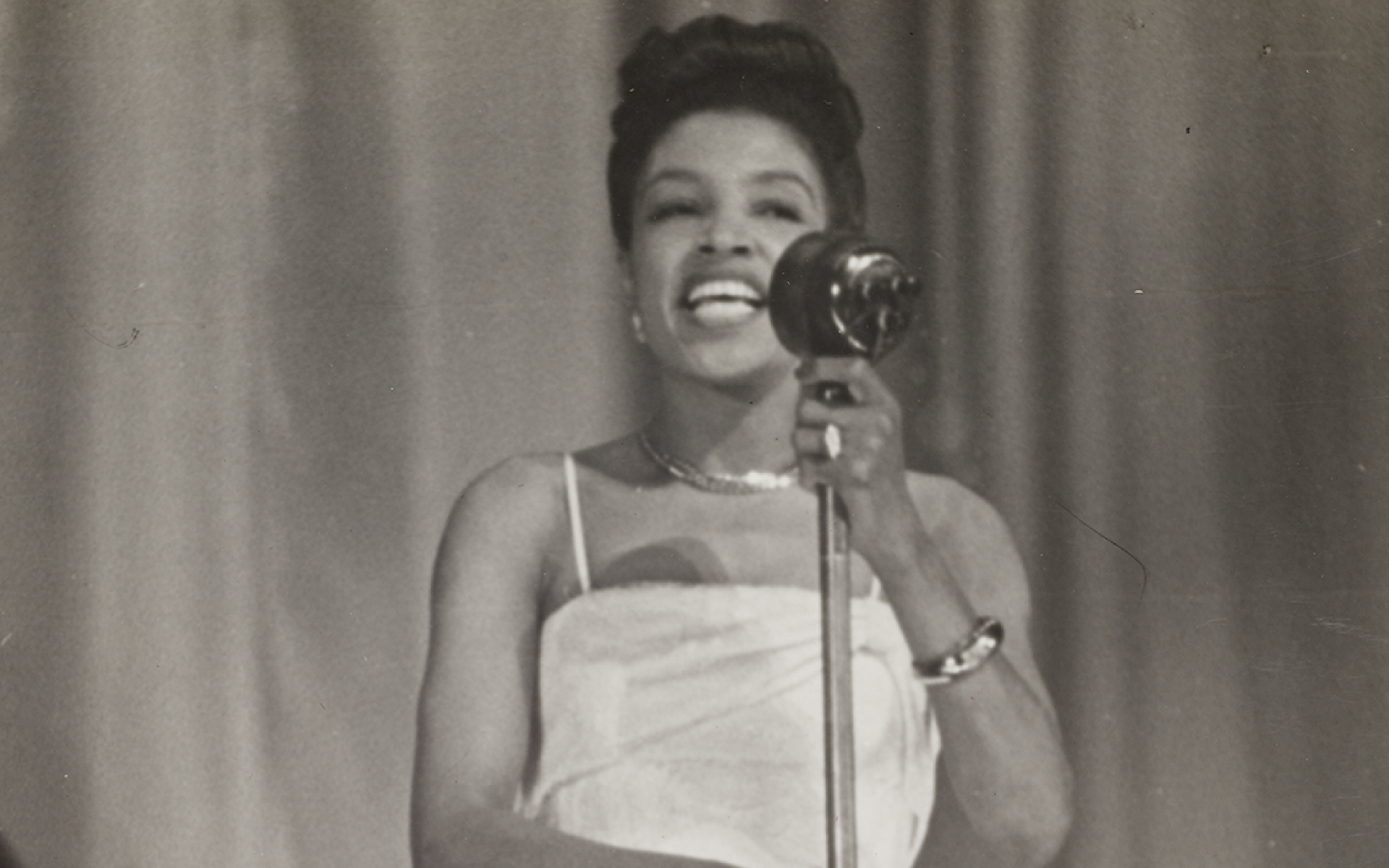 Maxine Sullivan singing into a microphone.