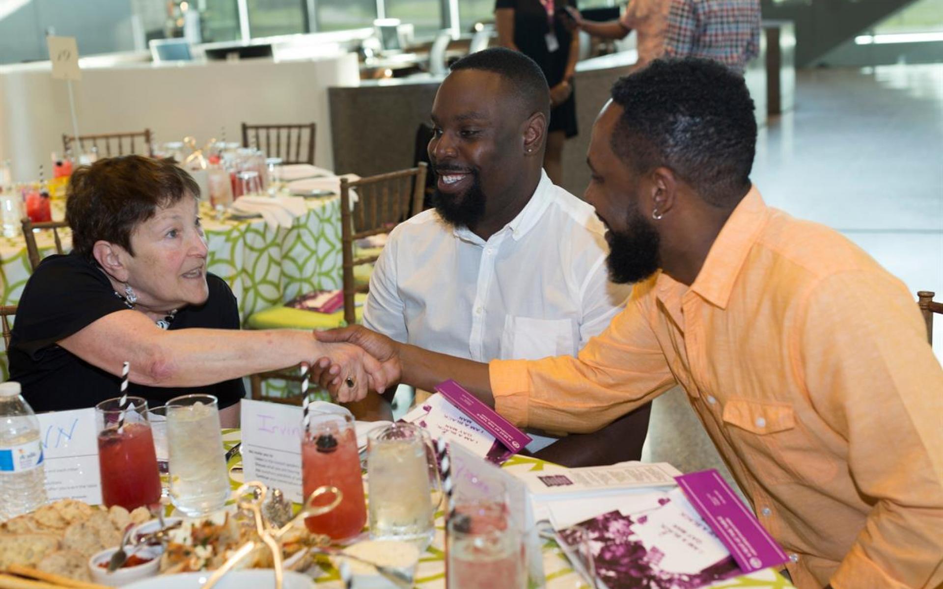 Program participants converse over a meal