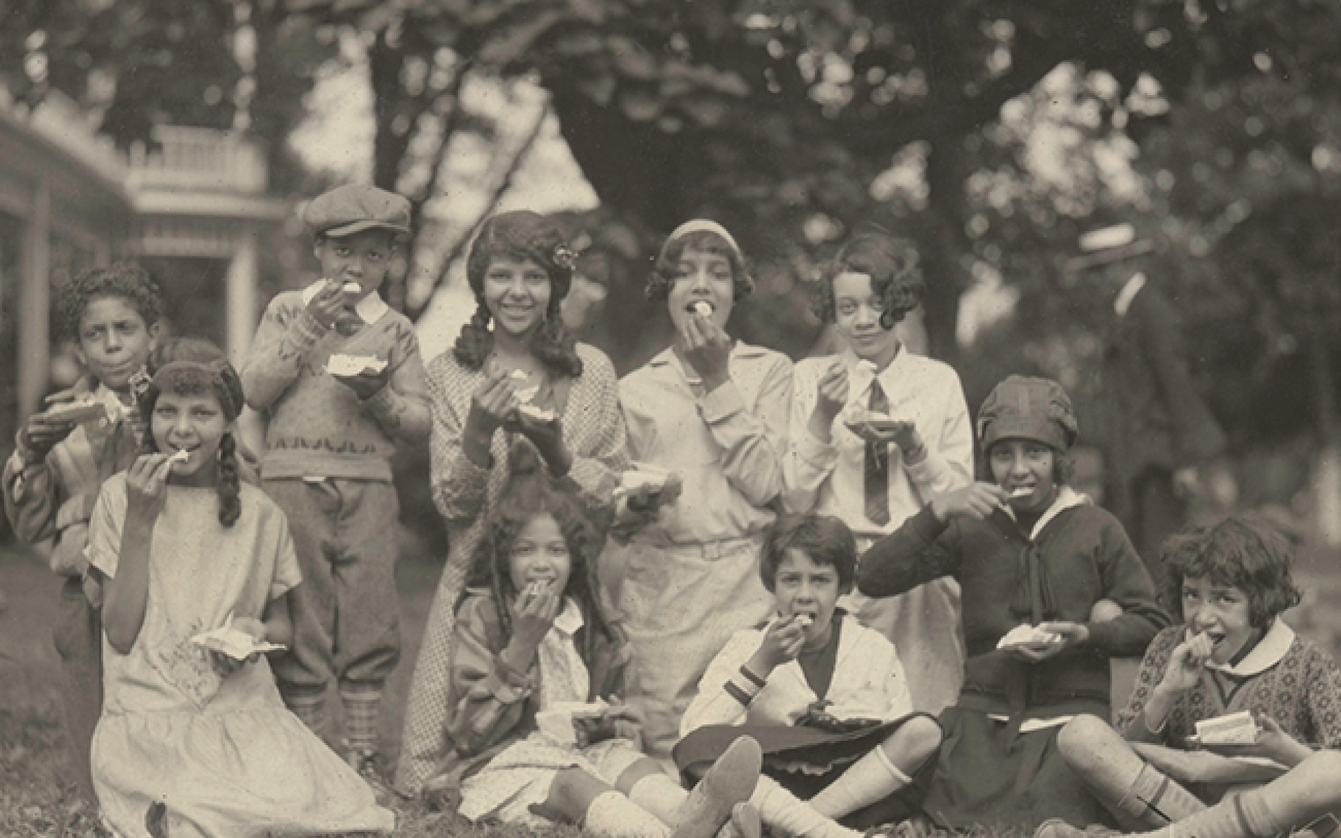 Black and white image of family outdoor meal