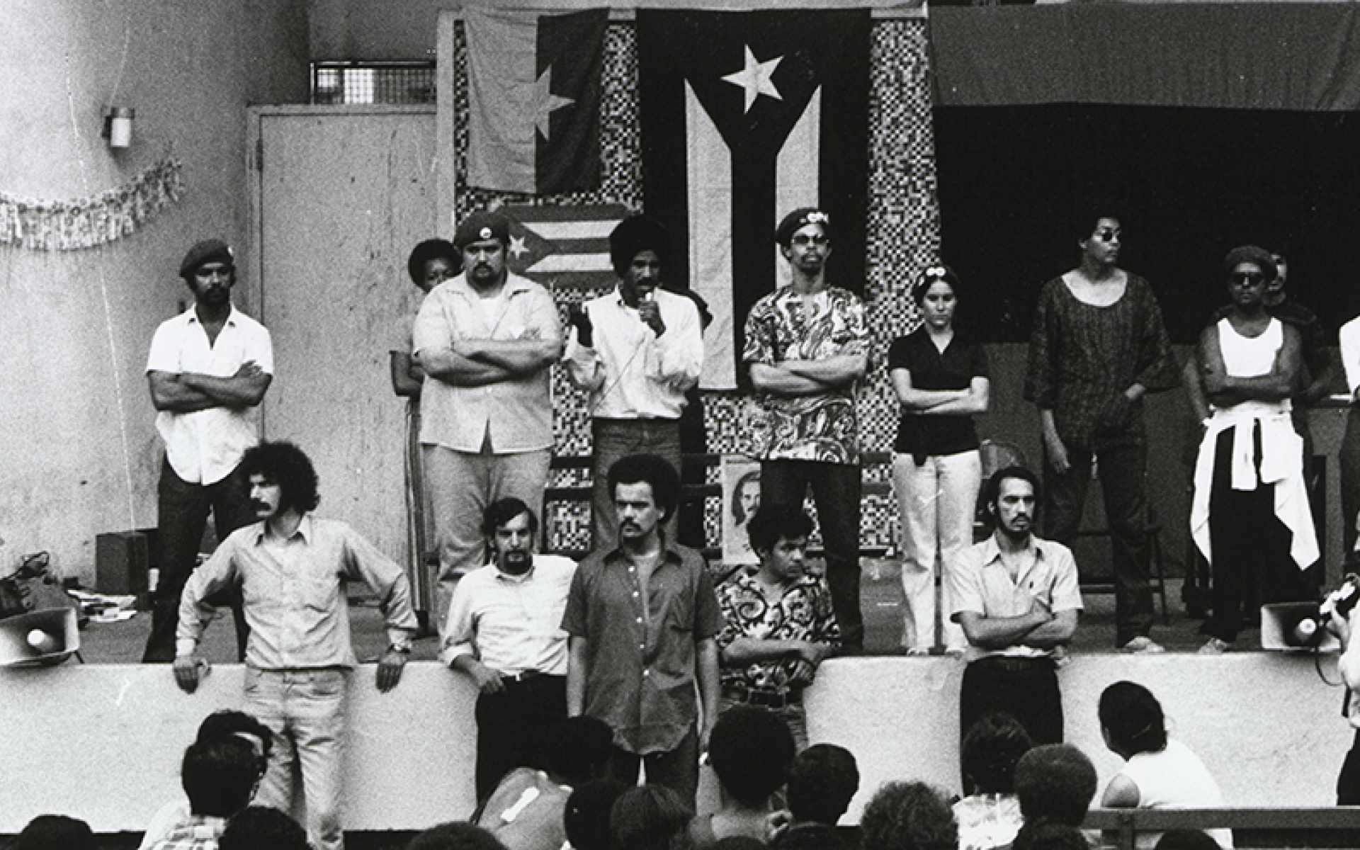 A black and white photograph of the Young Lords Rally at Tompkins Square Park in 1969