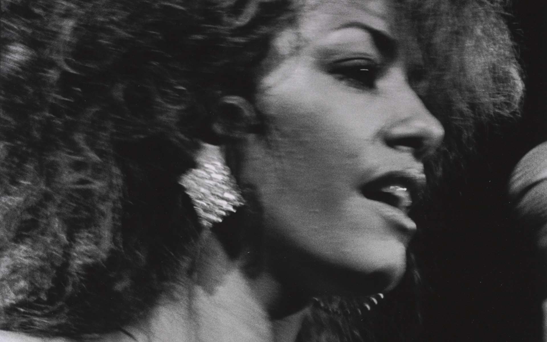 A black-and-white photograph of Sheila Escovedo, known as Sheila E., performing.