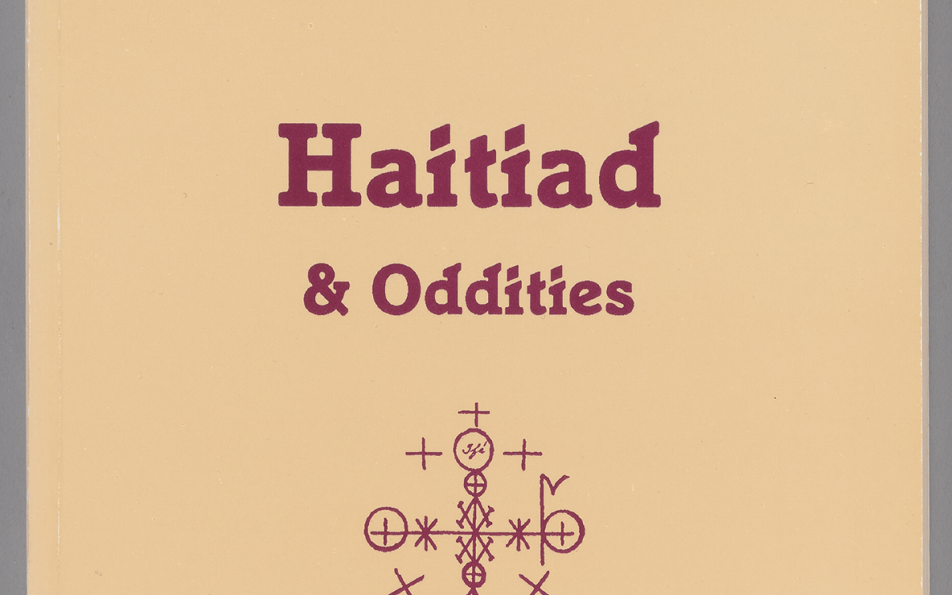 Tan paperback with red type on front cover. At center of front cover is a red religious symbol.