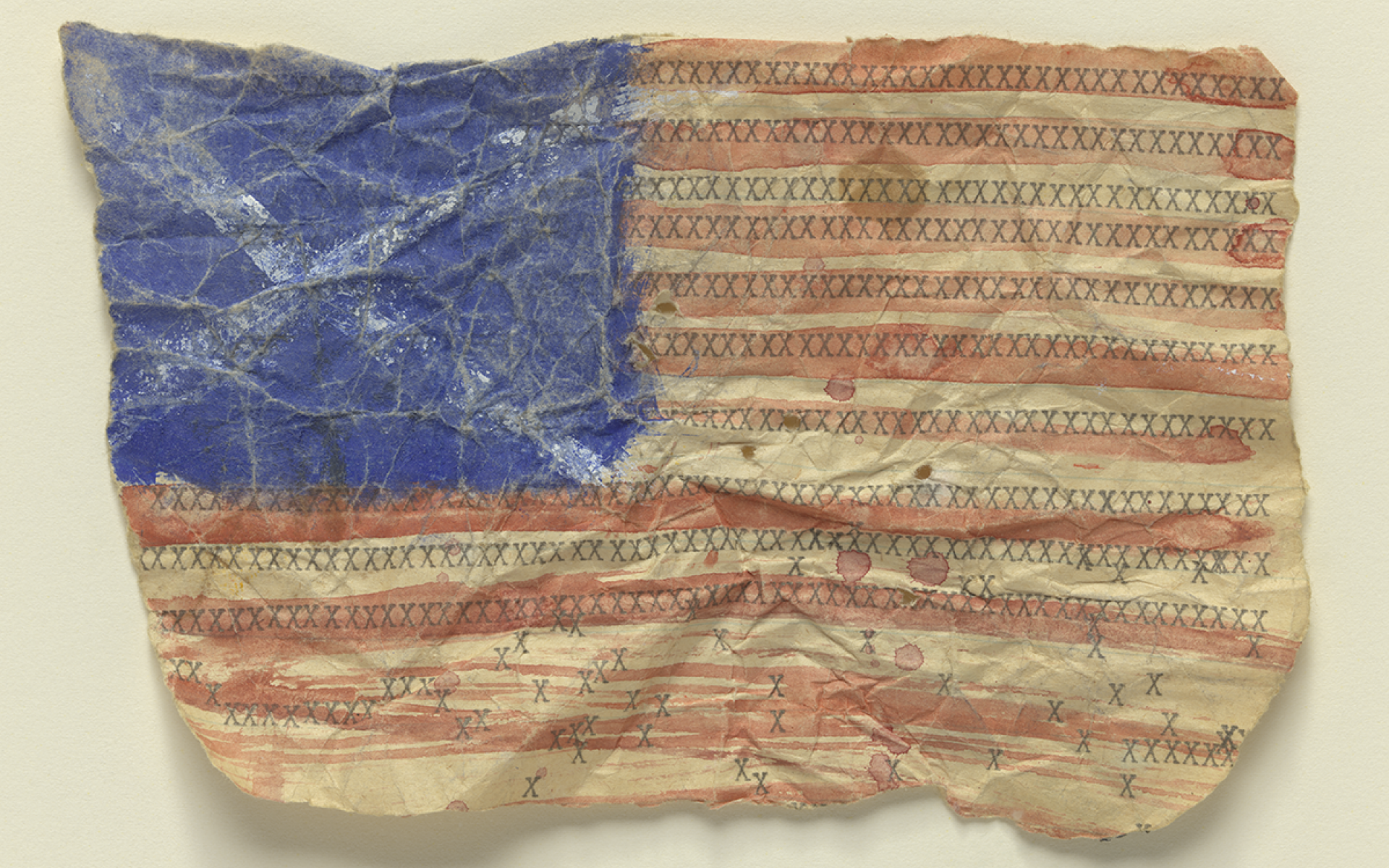 painted rendition of the American flag on a crumpled piece of paper