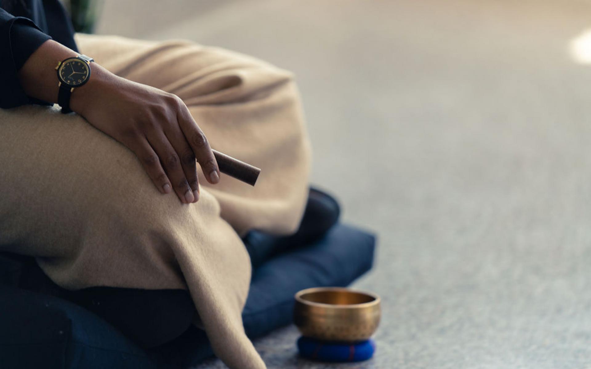 Image of woman sitting cross legged meditating