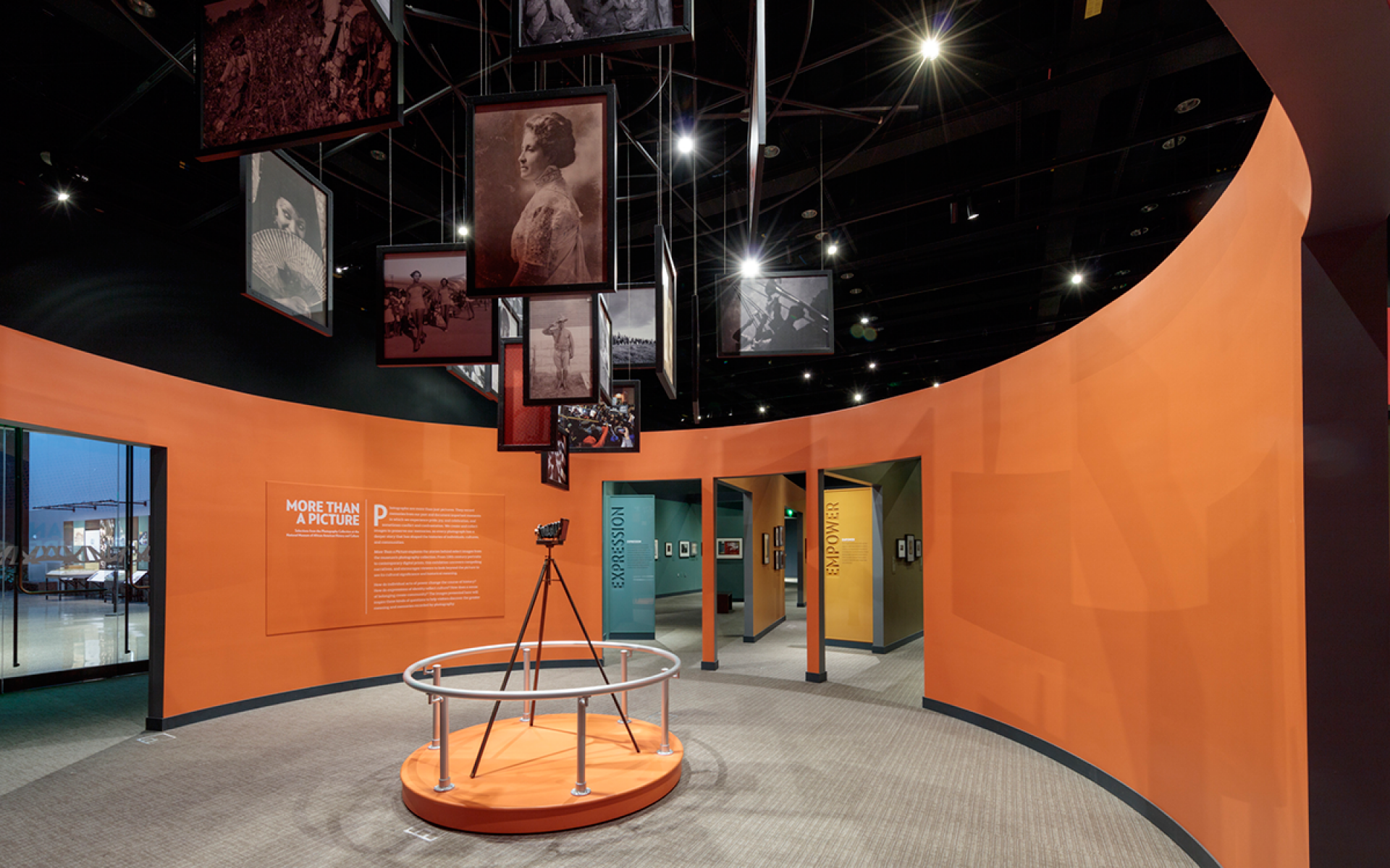 Central "vortex" in More Than A Picture with photographs hanging from the ceiling.